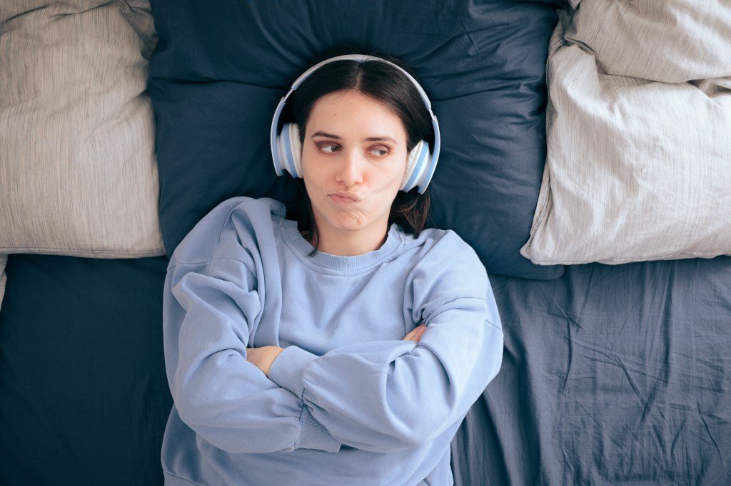 The woman wearing headphones that lift the noise