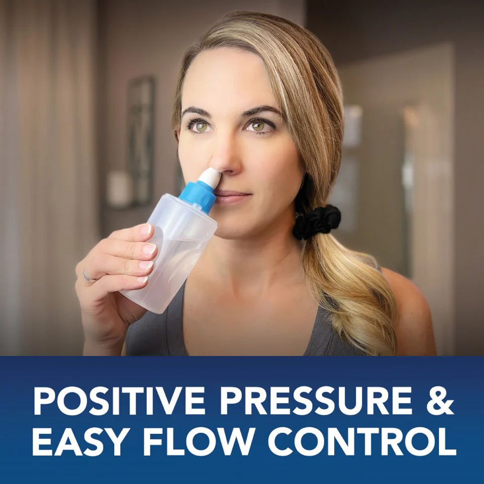 A woman uses Sinucleanse soft soft soft soft nasal washing system.