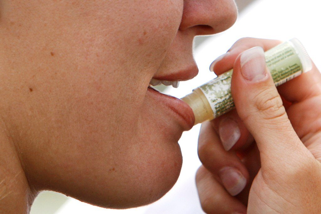 Woman who applies lip balm on her lips in Long Pond, Pennsylvania