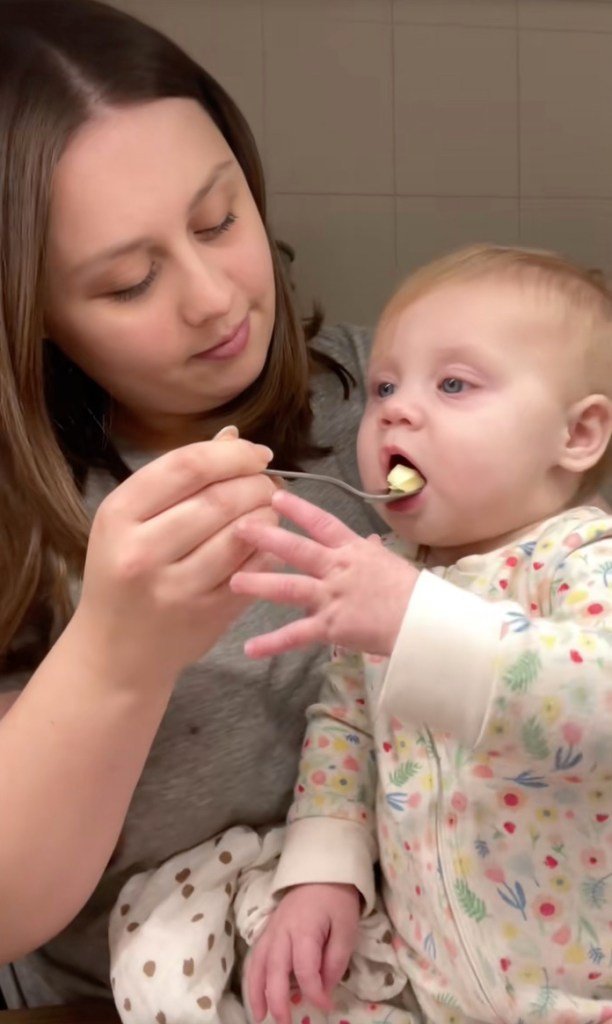 A tired mother giving her baby a spoonful of butter before bedtime, a trend of tiktok origin