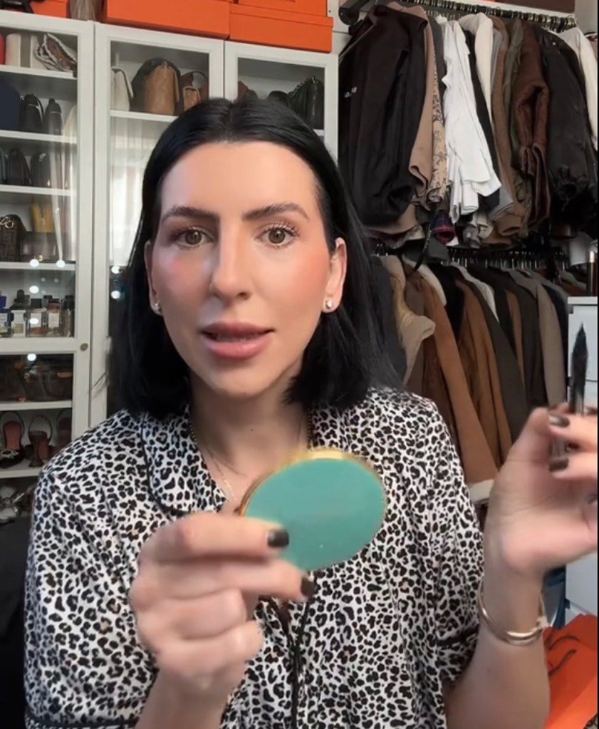 A woman holding a mirror in a video of NettyThebratty Tiktok